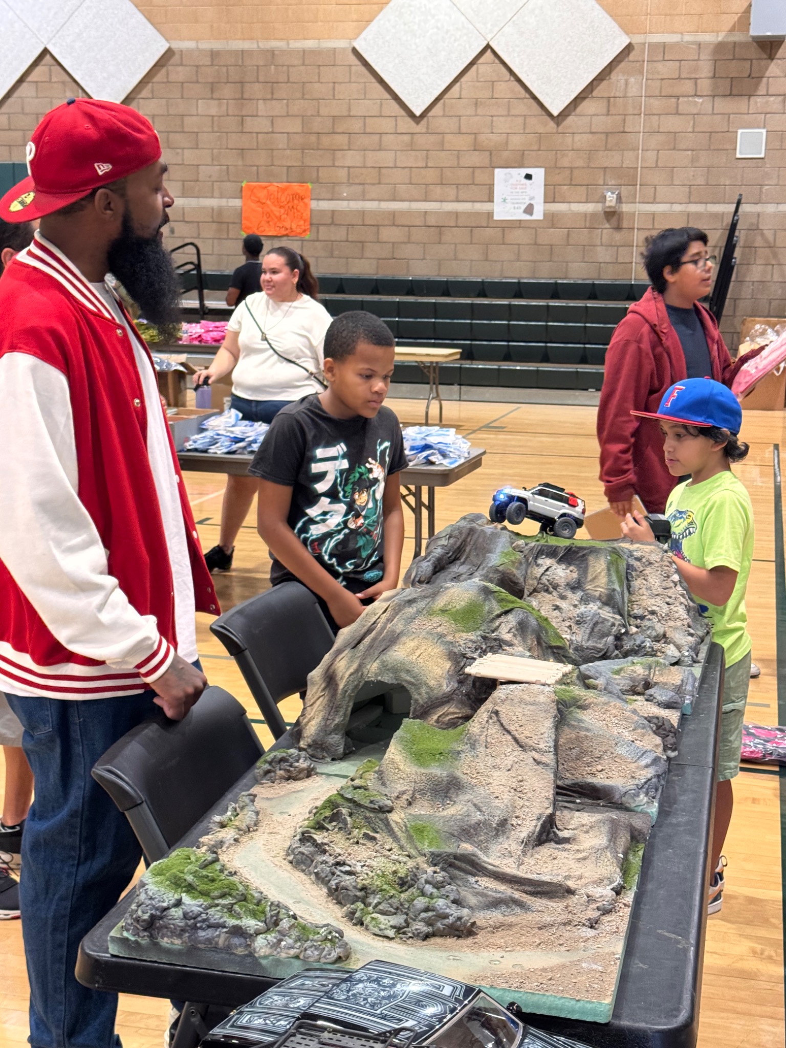 Mike guiding youth through an RC rock-crawling activity